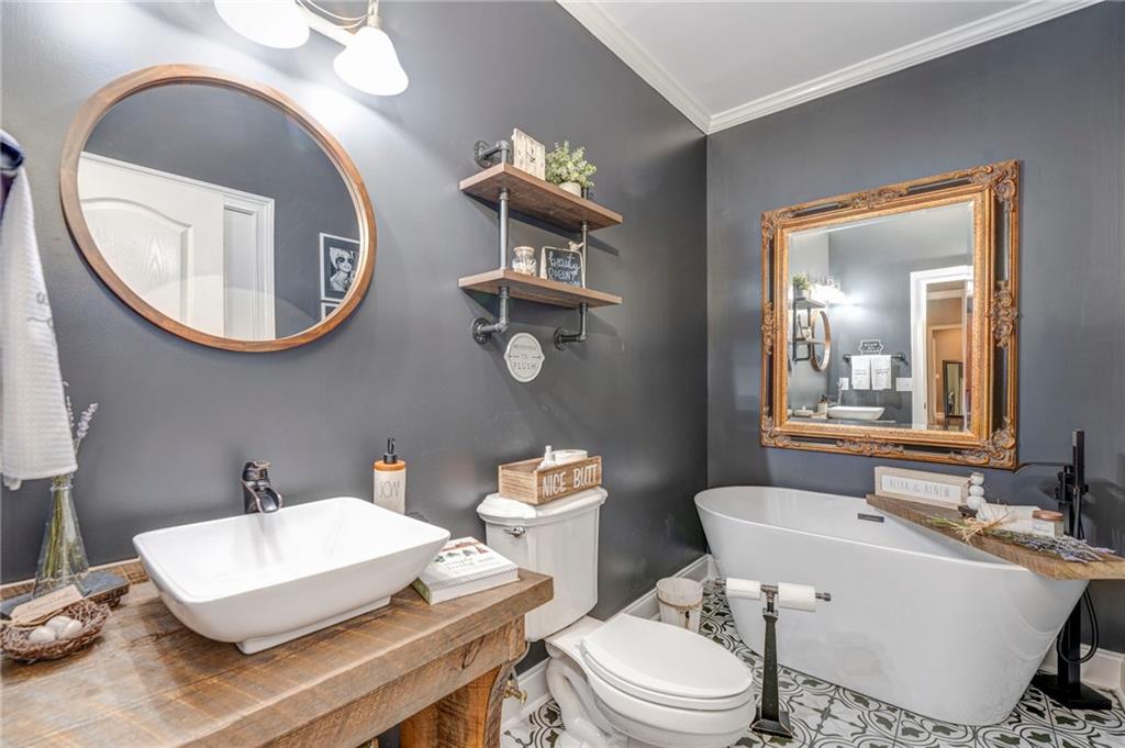 416 Spring Place Road Northeast White, GA 30184 - Photo 31 of 66 a bathroom with a toilet a sink and a mirror