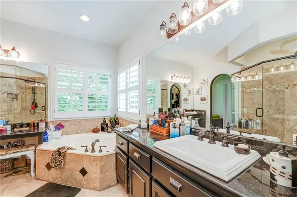 a bathroom with a sink vanity granite and a mirror