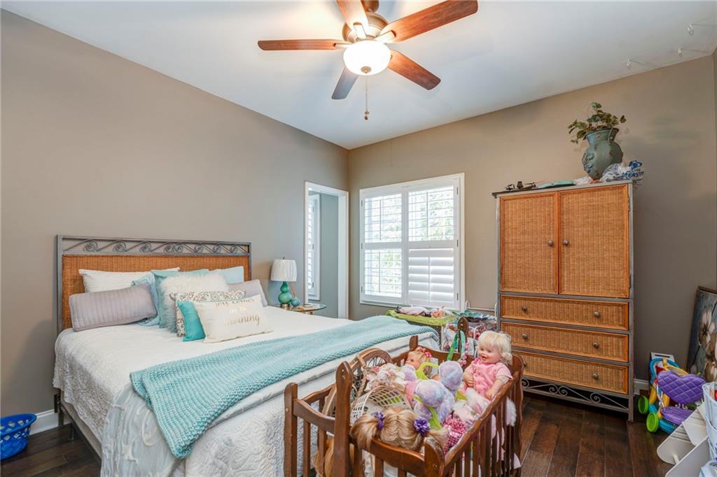 416 Spring Place Road Northeast White, GA 30184 - Photo 48 of 66 a bedroom with a bed and a chandelier