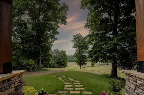 a view of a backyard with large trees