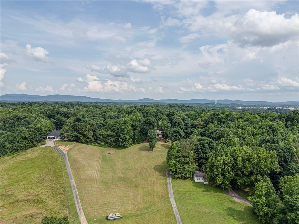 416 Spring Place Road Northeast White, GA 30184 - Photo 57 of 66 a view of a yard with swimming pool and trees in the background