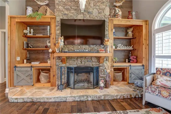 a living room with furniture fireplace and wooden floor