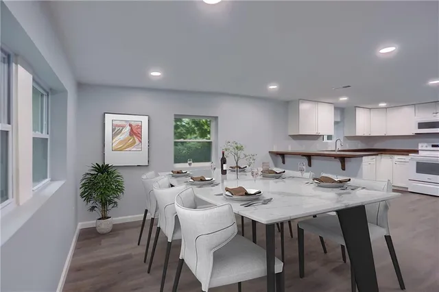 a view of a dining room with furniture window and wooden floor