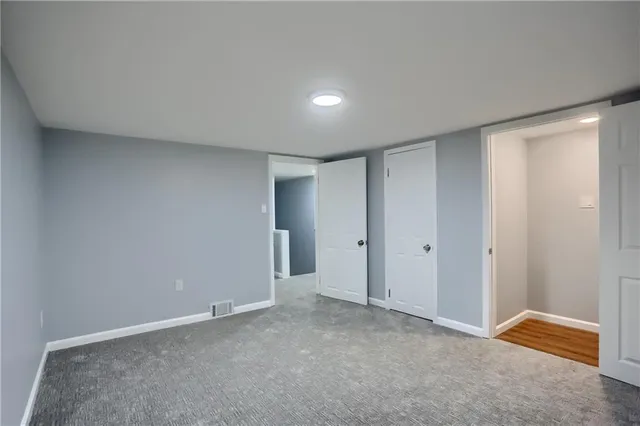 a view of an empty room and a window