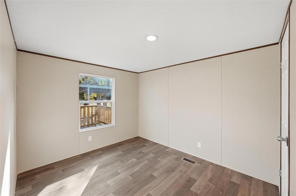 279 Carlisle Court Springtown, TX 76082 - Photo 13 of 18 a view of an empty room with a window and closet area