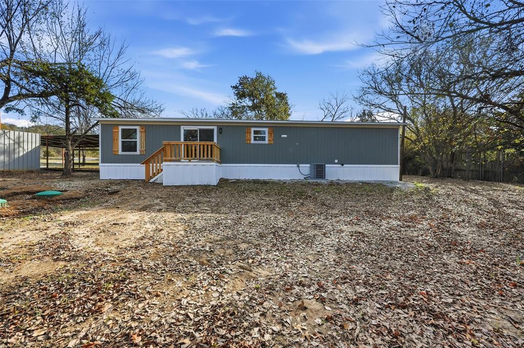 279 Carlisle Court Springtown, TX 76082 - Photo 16 of 18 a view of a house with a yard