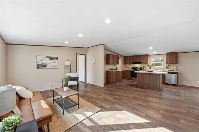a living room with furniture and kitchen view