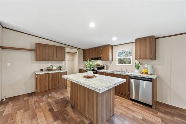 a kitchen with a stove sink and cabinets