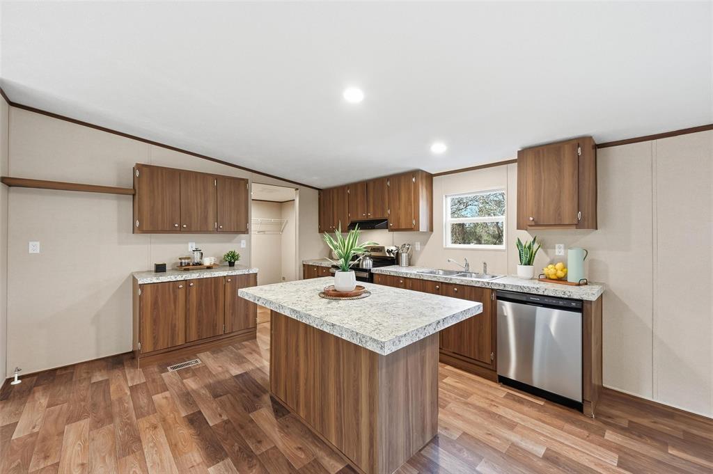 279 Carlisle Court Springtown, TX 76082 - Photo 4 of 18 a kitchen with a stove sink and cabinets
