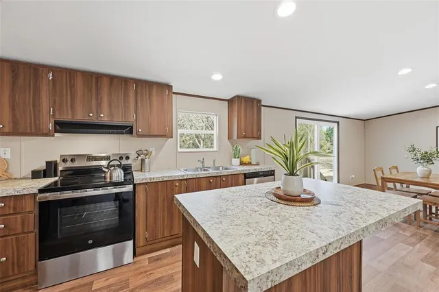 a kitchen with a stove a sink and a refrigerator