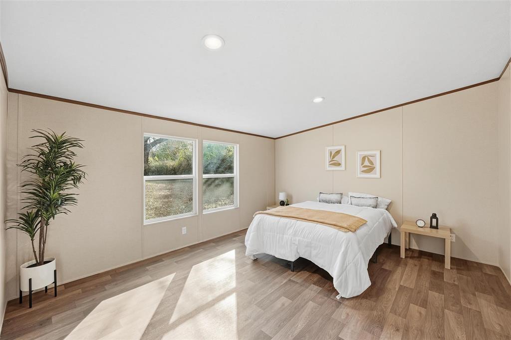 279 Carlisle Court Springtown, TX 76082 - Photo 8 of 18 a bedroom with a bed and a window