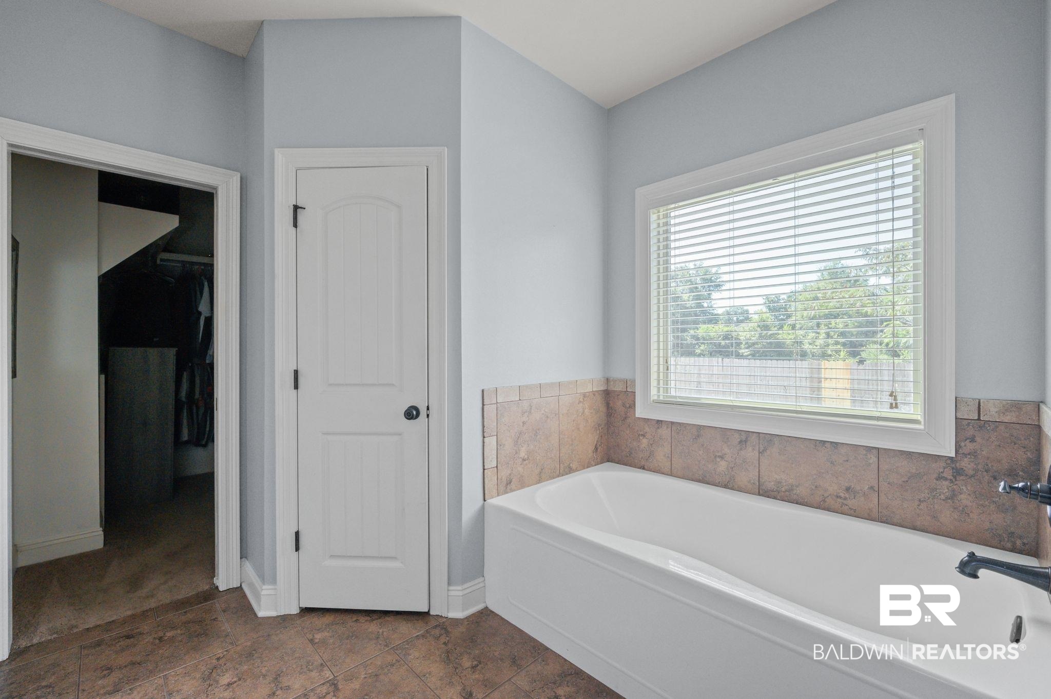 3879 Symphony Way West Semmes, AL 36575 - Photo 18 of 34 Bathroom featuring tile patterned flooring and a washtub