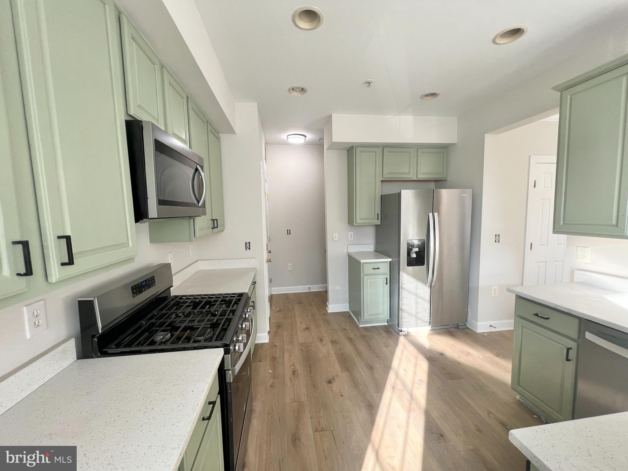 13548 Davinci Lane, Unit 46 Herndon, VA 20171 - Photo 12 of 28 a kitchen with a refrigerator and a sink