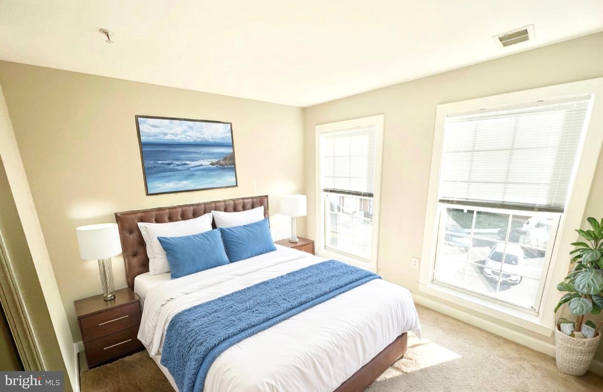13548 Davinci Lane, Unit 46 Herndon, VA 20171 - Photo 25 of 28 a bedroom with a bed and a window