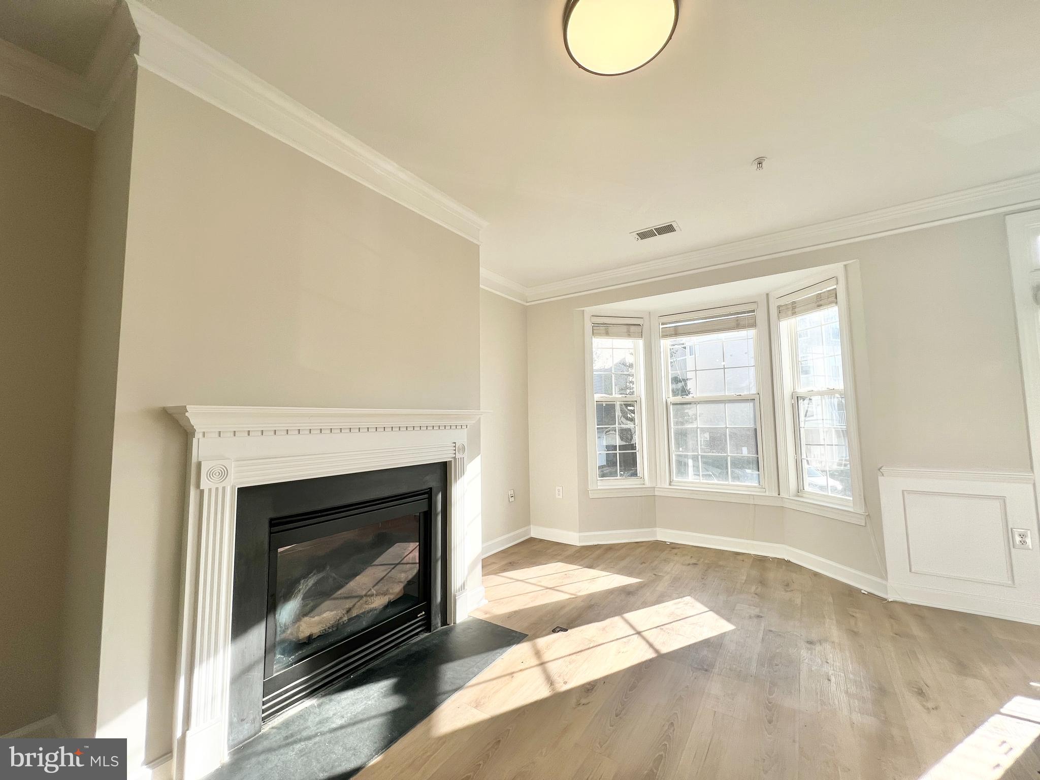 13548 Davinci Lane, Unit 46 Herndon, VA 20171 - Photo 4 of 28 a view of an empty room with a fireplace and a window