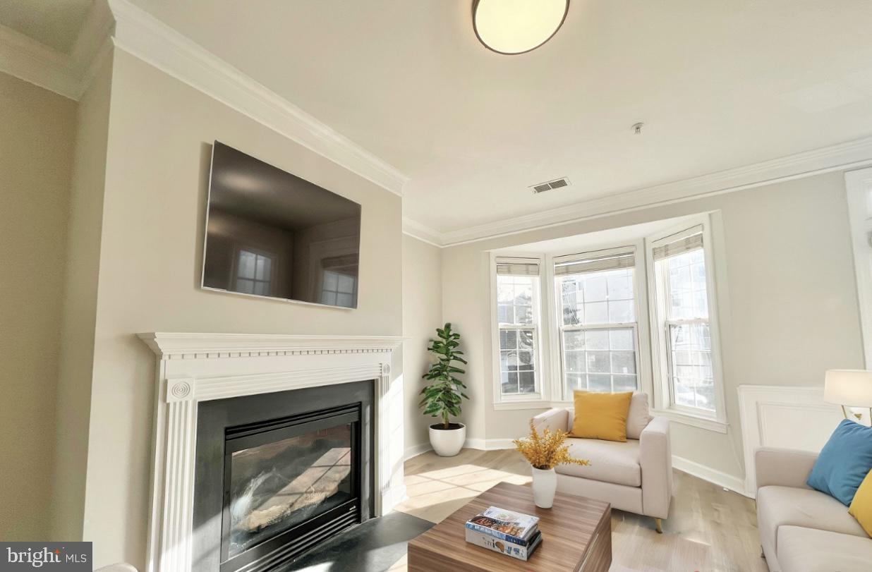 13548 Davinci Lane, Unit 46 Herndon, VA 20171 - Photo 5 of 28 a living room with furniture a flat screen tv and a fireplace