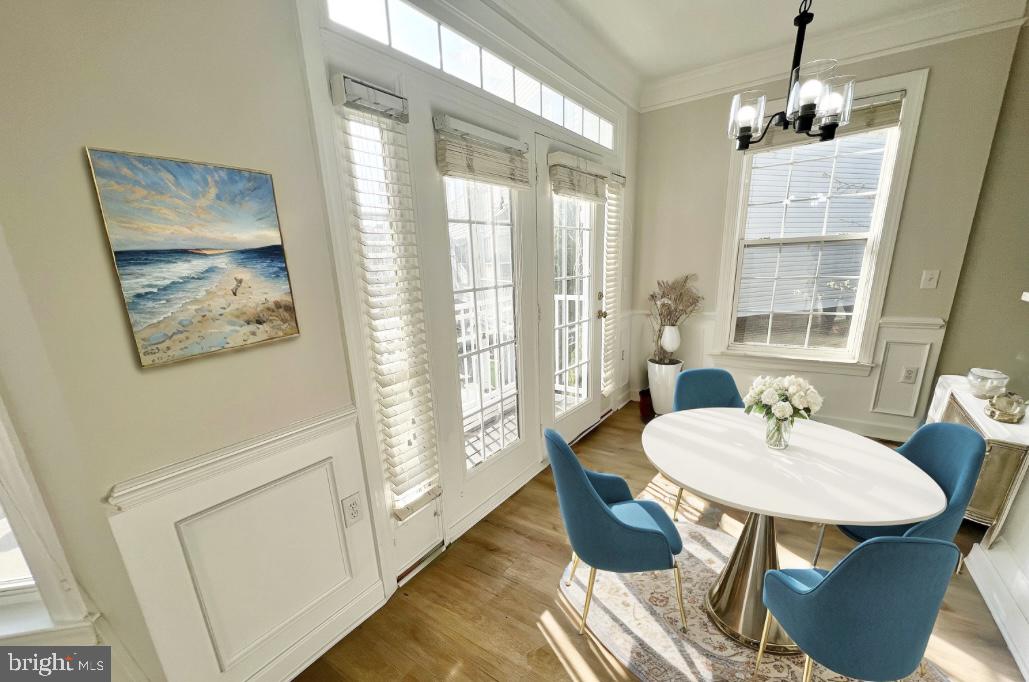 13548 Davinci Lane, Unit 46 Herndon, VA 20171 - Photo 8 of 28 a dining room with furniture a chandelier and wooden floor