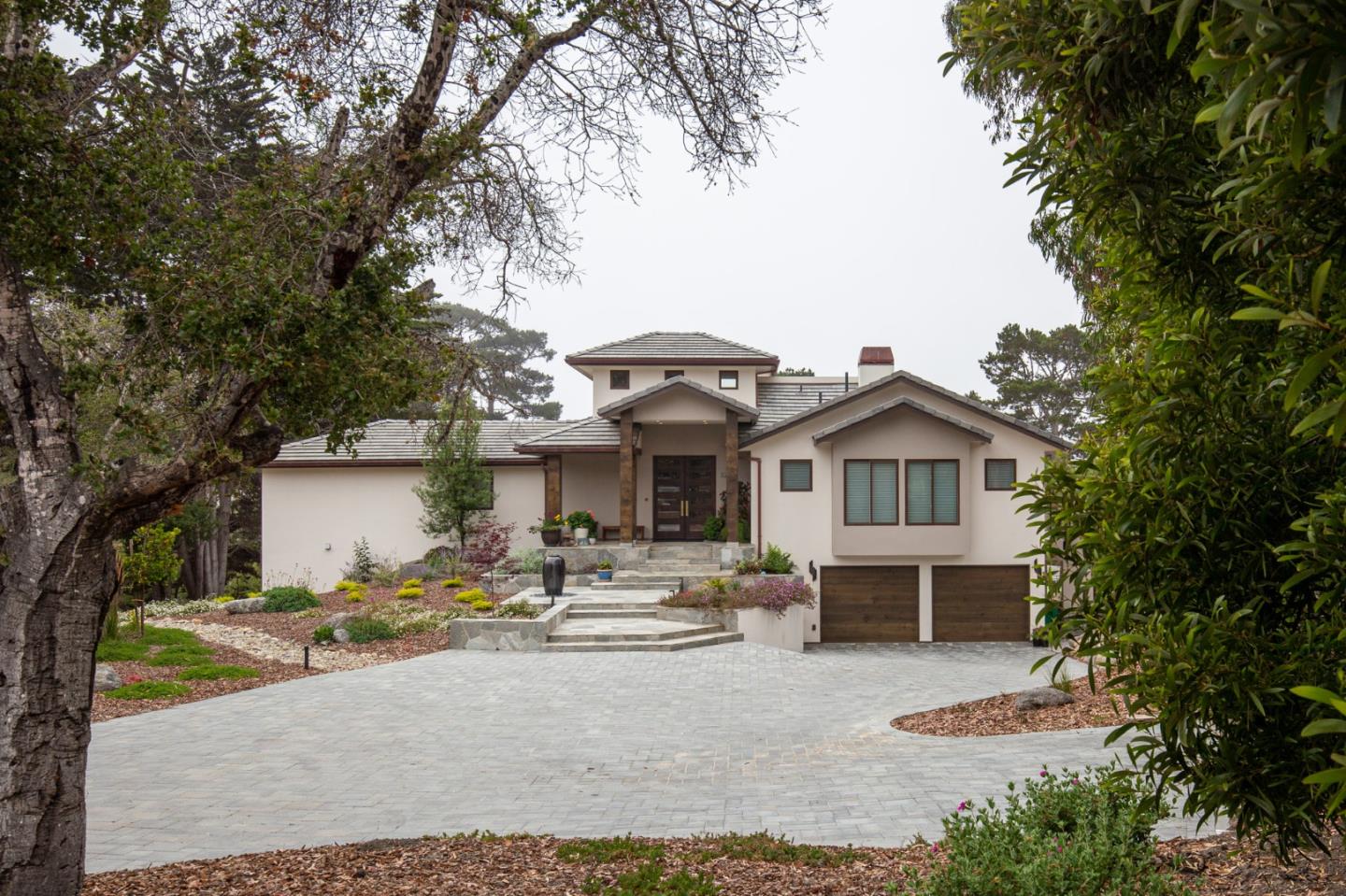 3292 Martin Road Carmel, CA 93923 - Photo 1 of 27 a front view of a house with a garden