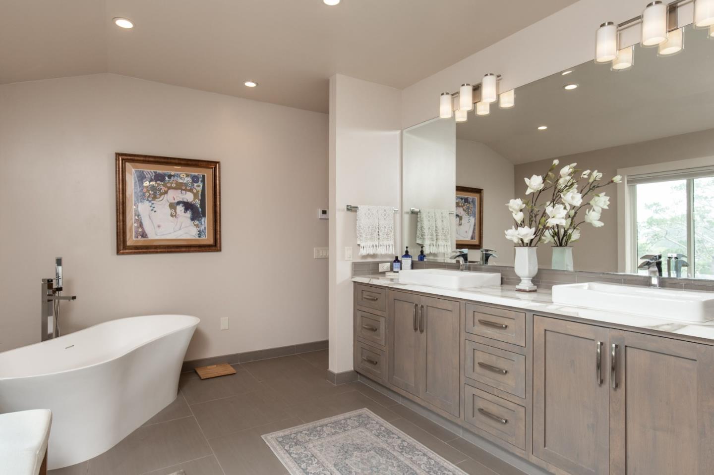 3292 Martin Road Carmel, CA 93923 - Photo 15 of 27 a spacious bathroom with a double vanity sink a mirror and a bathtub