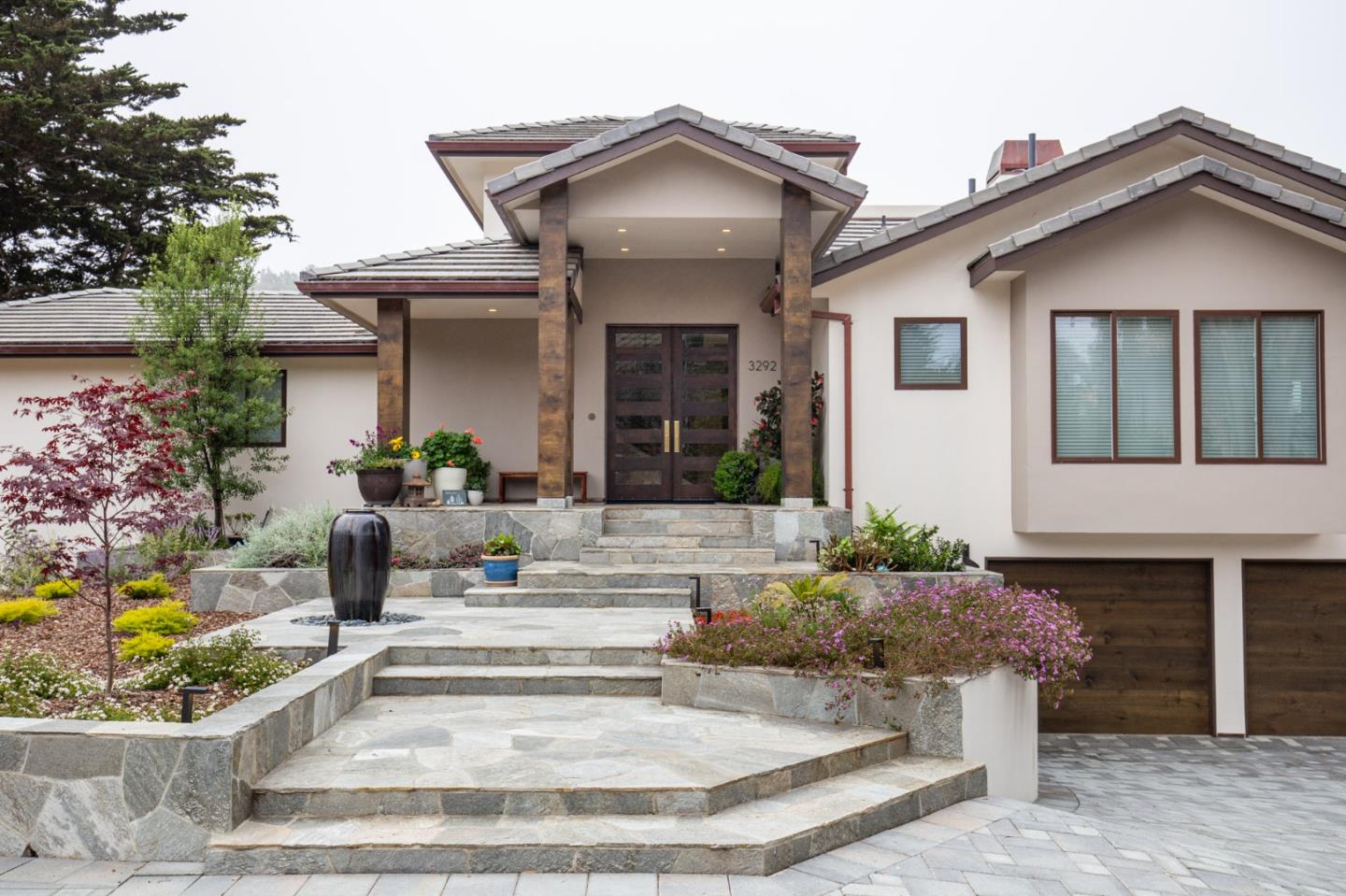 3292 Martin Road Carmel, CA 93923 - Photo 3 of 27 a view of a house with potted plants and a fountain