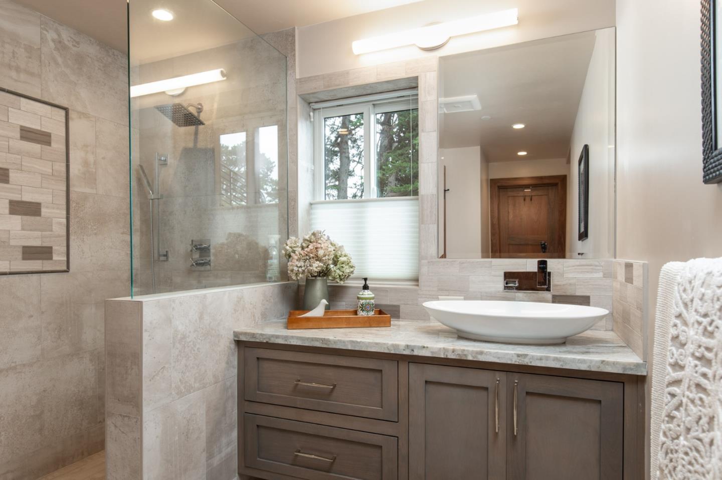 3292 Martin Road Carmel, CA 93923 - Photo 21 of 27 a bathroom with a granite countertop sink a mirror and a shower