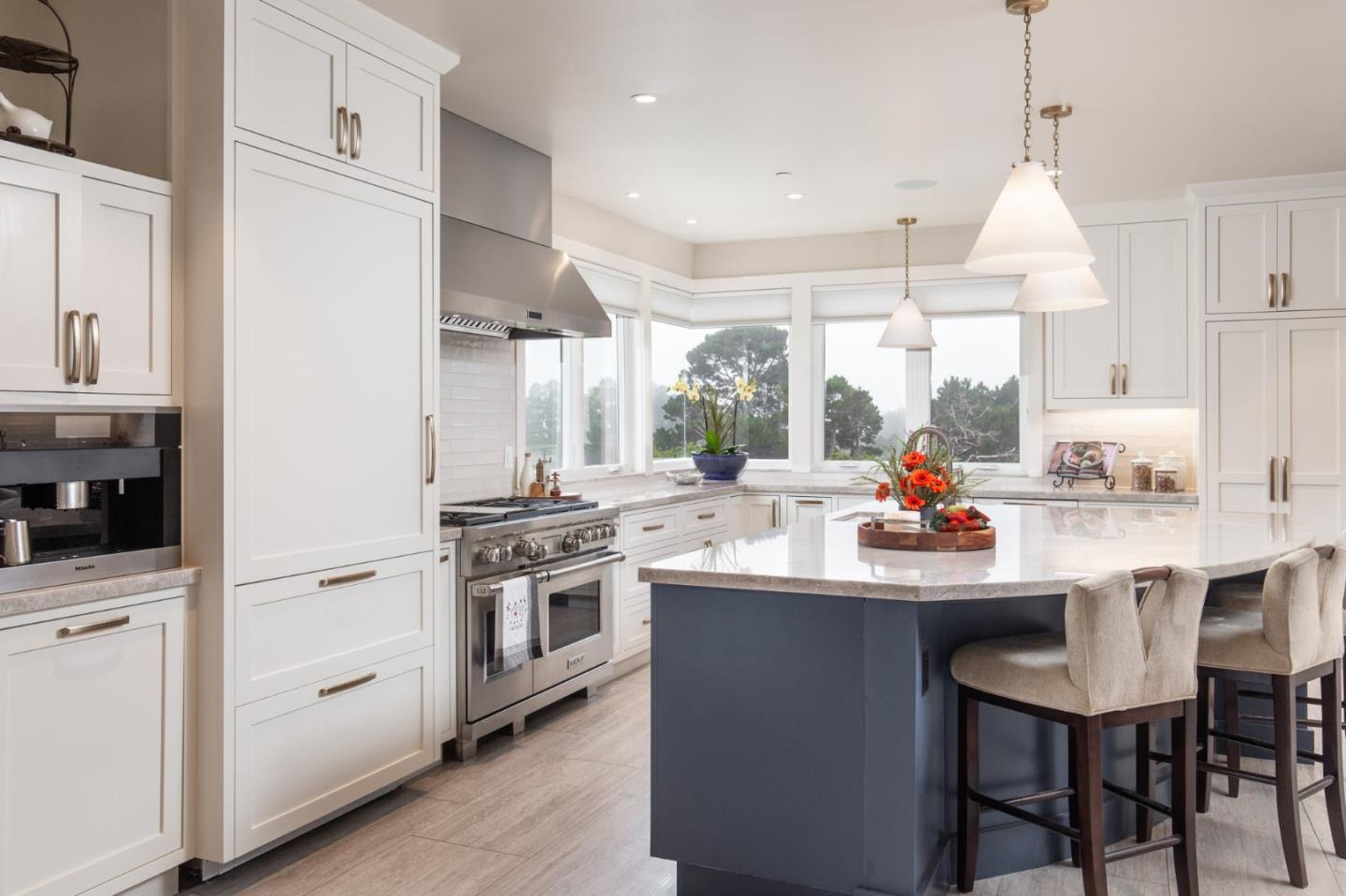 3292 Martin Road Carmel, CA 93923 - Photo 9 of 27 a kitchen with stainless steel appliances a sink stove and white cabinets with wooden floor