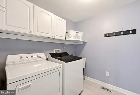 a bathroom with a double vanity sink toilet a shower and a mirror