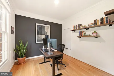 a living room with furniture and large windows