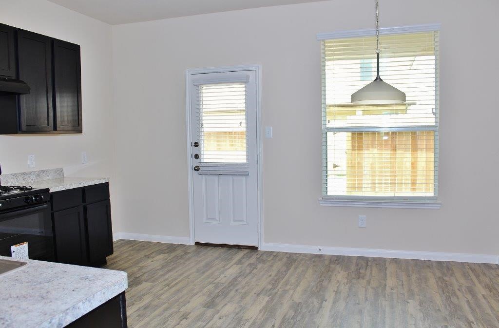 12227 Maura Lane Houston, TX 77044 - Photo 5 of 16 a view of a kitchen that shows a sink dishwasher and a microwave oven