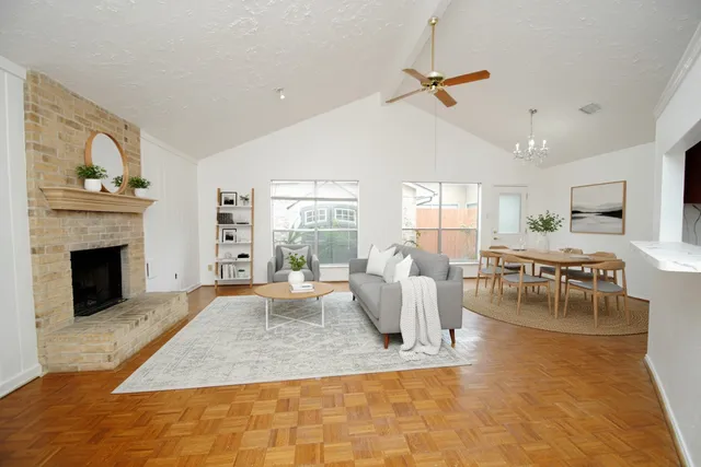 a living room with furniture a window and a fireplace