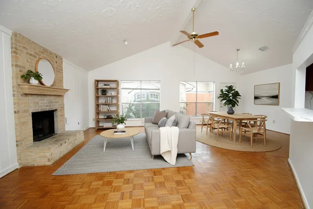 a living room with furniture floor to ceiling window and a fireplace