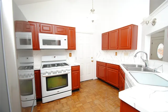 a kitchen with stainless steel appliances a stove a sink and a microwave