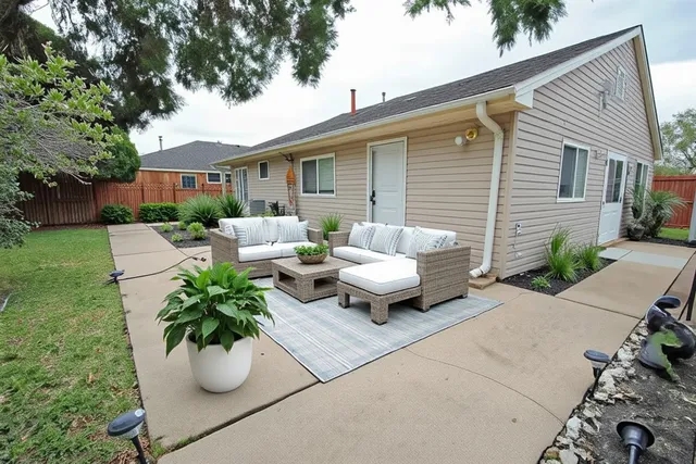 a view of a patio with table and chairs and potted plants