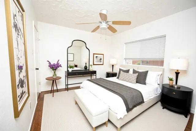 a bedroom with a bed and a chandelier