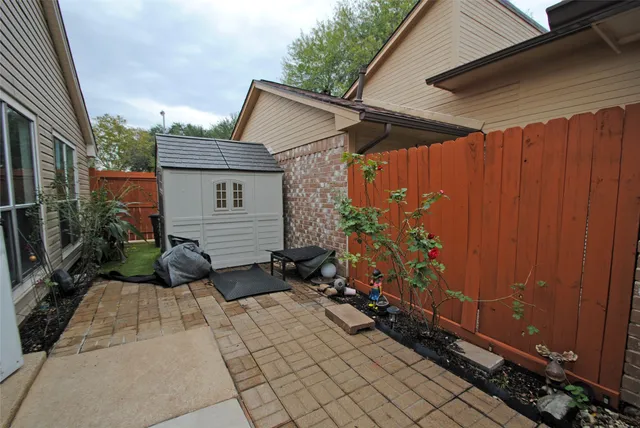 a backyard of a house with potted plants