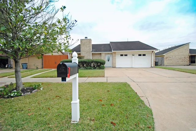 a house with sign broad in front of it