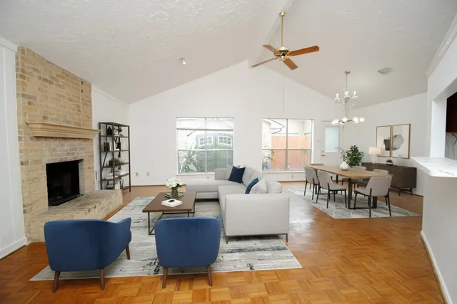 a living room with furniture wooden floor and a fireplace