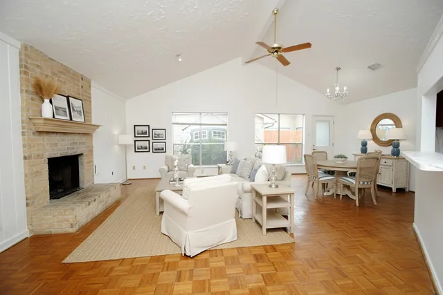 a living room with furniture a fireplace and a large window