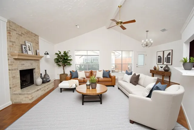 a living room with furniture and a fireplace