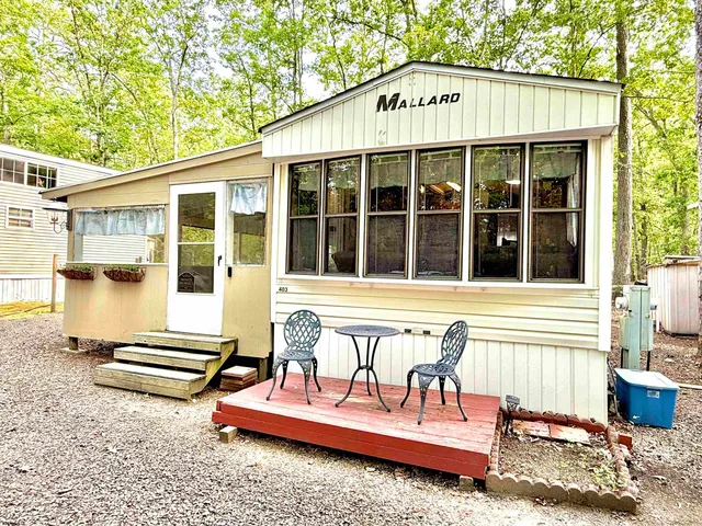 a front view of a house with a sitting area