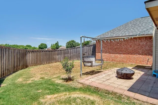 a swimming pool with some trees in the background