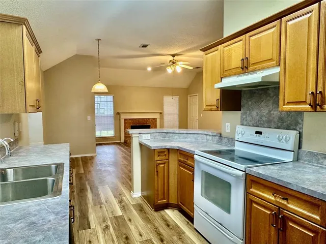 a kitchen with a sink stove and cabinets