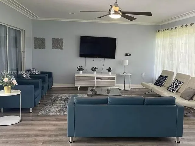 a living room with furniture and a flat screen tv