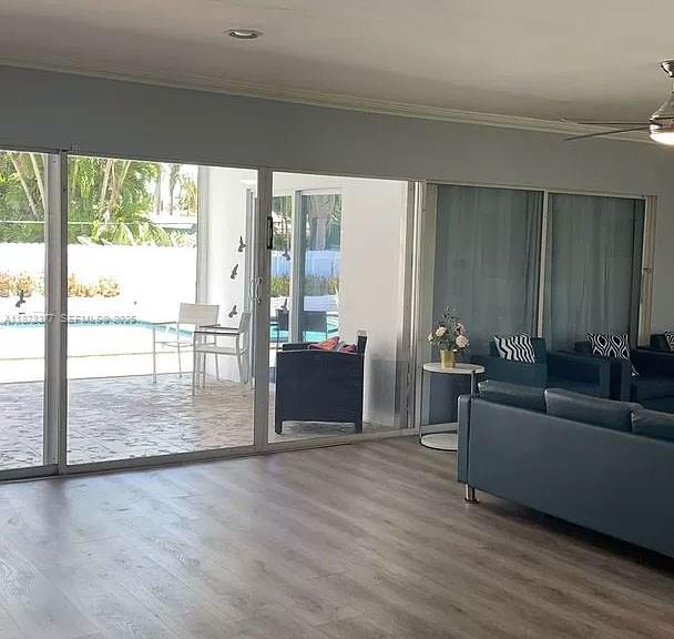 1319 Fillmore Street Hollywood, FL 33019 - Photo 15 of 15 a living room with furniture and a floor to ceiling window