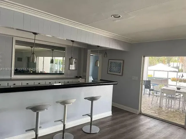 a kitchen with a sink and a large window