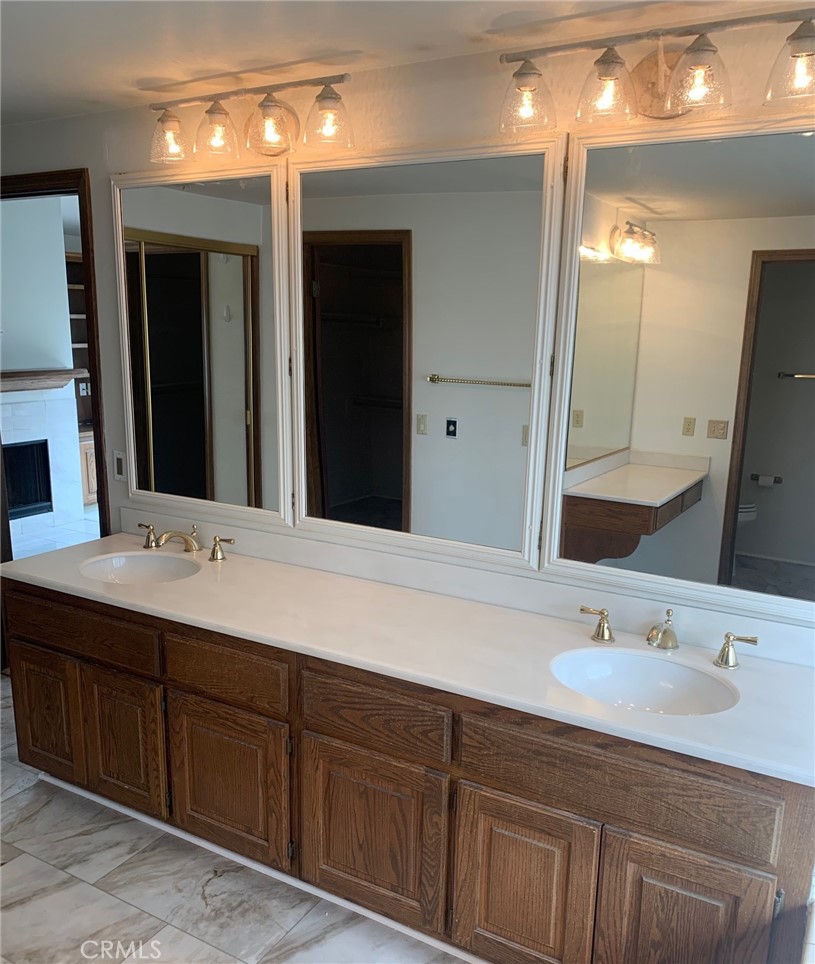 2 Cambridge Manhattan Beach, CA 90266 - Photo 18 of 18 a bathroom with double vanity sinks and a large mirror