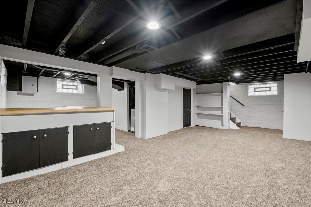 1056 Quilliams Road Cleveland, OH 44121 - Photo 29 of 37 Basement with stairway, light carpet, and electric panel