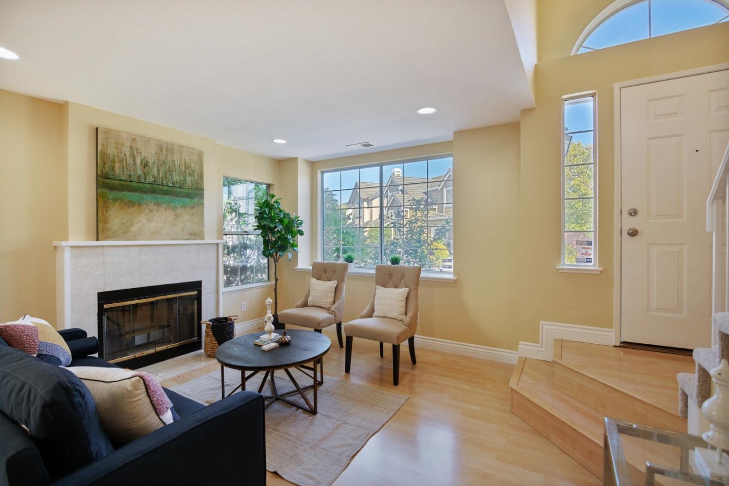 933 Coventry Way Milpitas, CA 95035 - Photo 2 of 30 a living room with furniture a fireplace and a large window