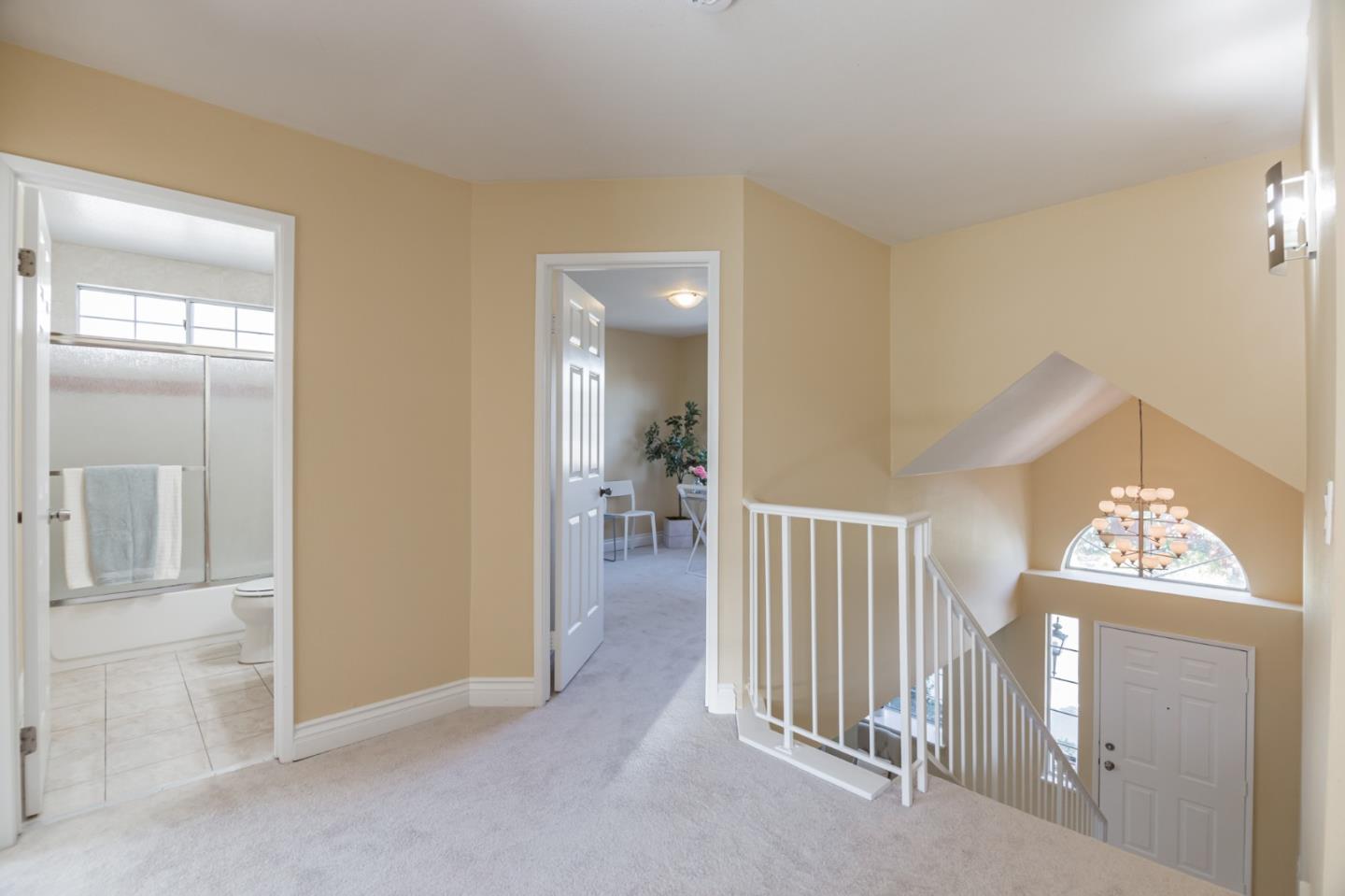 933 Coventry Way Milpitas, CA 95035 - Photo 16 of 30 hallway with wooden floor and windows