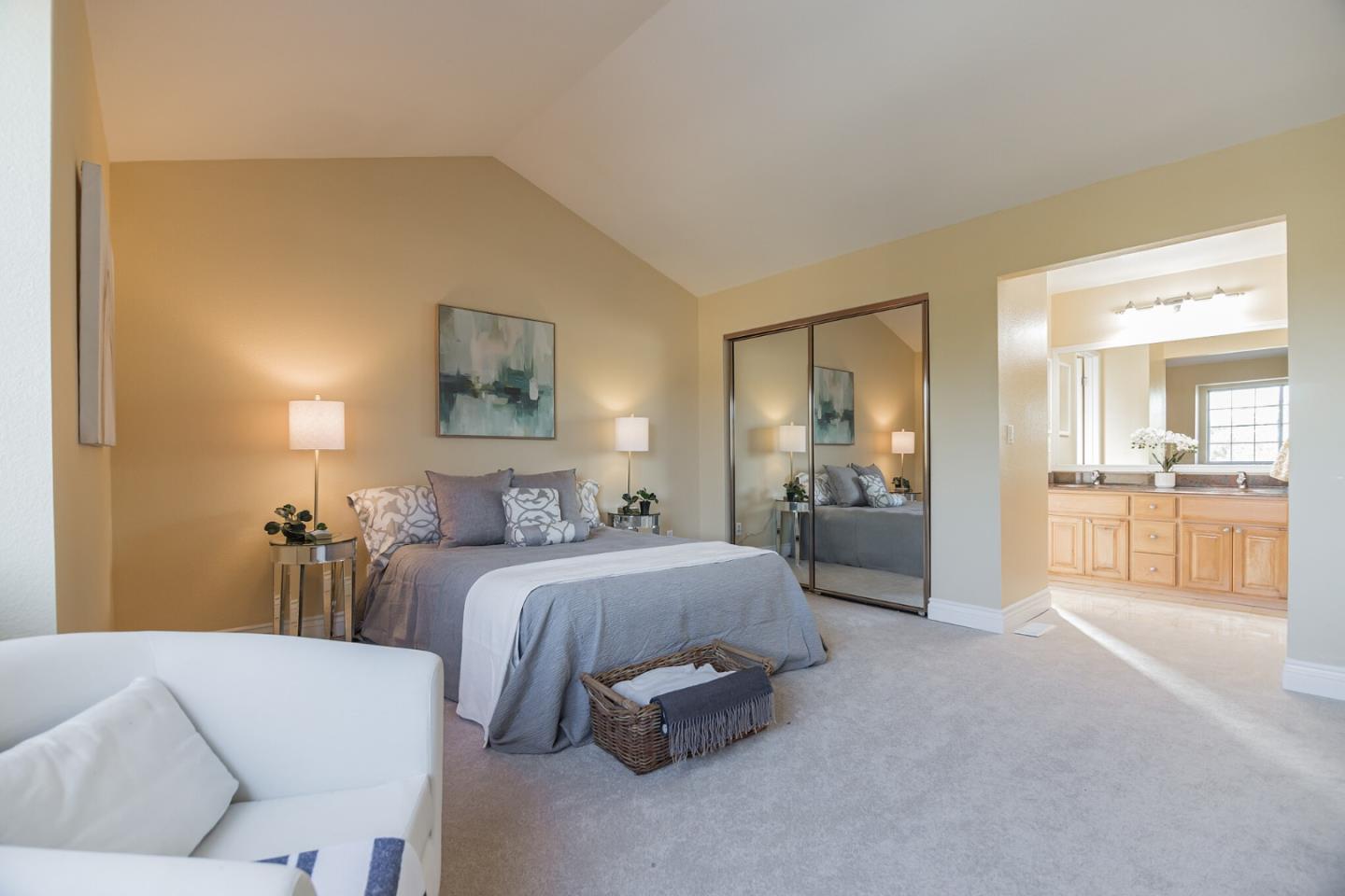 933 Coventry Way Milpitas, CA 95035 - Photo 19 of 30 a spacious bedroom with a bed and glass cabinets